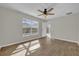 Bright bedroom with fan, wood floors, large window, and a glass door offering great natural light at 1533 Loch Avich Rd, Winter Garden, FL 34787