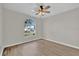 Bedroom with fan, large arch window, and neutral walls for a calm, inviting space at 1533 Loch Avich Rd, Winter Garden, FL 34787