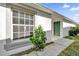 Home exterior featuring light-grey paint, a green front door, and a well-maintained walkway at 1533 Loch Avich Rd, Winter Garden, FL 34787