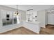 Bright kitchen featuring an island with quartz countertop, modern pendant lights, and stainless appliances at 1533 Loch Avich Rd, Winter Garden, FL 34787