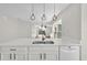 Bright kitchen featuring island with quartz countertop, modern pendant lights, and a stainless dishwasher at 1533 Loch Avich Rd, Winter Garden, FL 34787