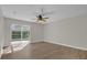Bright living room featuring wood floors, fan, and sliding glass doors to the outside at 1533 Loch Avich Rd, Winter Garden, FL 34787