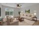 Comfortable living room with a decorative rug, neutral sofa set, wall art, and a ceiling fan at 1533 Loch Avich Rd, Winter Garden, FL 34787