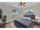 Staged bedroom with a comfy bed, modern decor, and a large window for natural light at 1533 Loch Avich Rd, Winter Garden, FL 34787