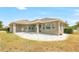 Beautiful outdoor living space with a paver patio, tan house, and a partially-fenced yard at 2781 Sand Oak Loop, Apopka, FL 32712
