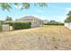 Expansive fenced backyard with covered patio, offering ample space for outdoor activities and relaxation at 2781 Sand Oak Loop, Apopka, FL 32712