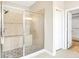 Glass enclosed shower with seat and pebble floor design inside a modern bathroom at 2781 Sand Oak Loop, Apopka, FL 32712