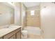 This bathroom features a shower and tub combination and a tiled backsplash at 2781 Sand Oak Loop, Apopka, FL 32712