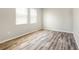 Bedroom with wood-style flooring and two windows allowing natural light at 2781 Sand Oak Loop, Apopka, FL 32712