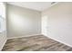 This bedroom features plank flooring, a window, and neutral paint tones at 2781 Sand Oak Loop, Apopka, FL 32712