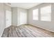 Spacious bedroom featuring wood-style floors, large windows, and a closet at 2781 Sand Oak Loop, Apopka, FL 32712