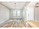 Elegant dining room showcasing wood-look flooring, a chandelier, and natural light at 2781 Sand Oak Loop, Apopka, FL 32712