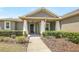 Inviting front porch featuring stately columns, a ceiling fan, and lovely landscaping at 2781 Sand Oak Loop, Apopka, FL 32712