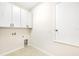 Laundry room with white cabinets, tile flooring, and utility connections at 2781 Sand Oak Loop, Apopka, FL 32712