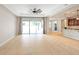 Open-concept living room featuring tile flooring, recessed lighting, and sliding glass doors to the lanai at 2781 Sand Oak Loop, Apopka, FL 32712