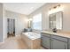 Elegant primary bathroom offers soaking tub, double vanity, tile floors, and separate shower at 2781 Sand Oak Loop, Apopka, FL 32712