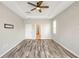 Large primary suite features tray ceiling, wood floors, and ample natural light at 2781 Sand Oak Loop, Apopka, FL 32712