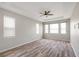 Primary bedroom features wood floors, tray ceiling, neutral paint and lots of windows at 2781 Sand Oak Loop, Apopka, FL 32712