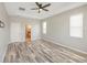 Spacious primary bedroom with trey ceilings, recessed lighting, wood floors and a ceiling fan at 2781 Sand Oak Loop, Apopka, FL 32712