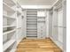 Walk-in closet featuring custom shelving and drawer unit with a modern design at 2781 Sand Oak Loop, Apopka, FL 32712