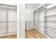 Spacious walk-in closet with custom shelving, drawers, and wood-style floors at 2781 Sand Oak Loop, Apopka, FL 32712