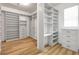 Large walk-in closet features custom shelving, drawers, and laminate wood floors at 2781 Sand Oak Loop, Apopka, FL 32712