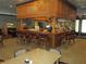 Inviting bar area with classic wooden finishes, comfortable seating, and a fully stocked counter at 3621 Arlington Ridge Blvd, Leesburg, FL 34748