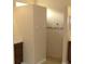 Bright bathroom featuring a tiled shower and vanity with dark wood cabinets at 3621 Arlington Ridge Blvd, Leesburg, FL 34748