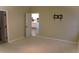 View of the bedroom from the entry with access to the kitchen at 3621 Arlington Ridge Blvd, Leesburg, FL 34748