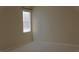 Carpeted bedroom with a window, blinds, and natural lighting at 3621 Arlington Ridge Blvd, Leesburg, FL 34748