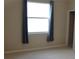 This bedroom has carpet flooring, neutral walls, and a window with gray curtains at 3621 Arlington Ridge Blvd, Leesburg, FL 34748