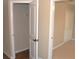 Open closet featuring a wire rack and wood-look flooring with a door leading to a bedroom at 3621 Arlington Ridge Blvd, Leesburg, FL 34748
