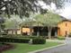 Exterior view of a clubhouse with covered entrance, well-kept landscaping, and classic architectural details at 3621 Arlington Ridge Blvd, Leesburg, FL 34748