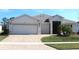 Charming single-story home featuring a well-manicured lawn and a brick-paved driveway leading to a spacious three-car garage at 3621 Arlington Ridge Blvd, Leesburg, FL 34748