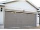 Exterior view of a garage with a retractable screen at 3621 Arlington Ridge Blvd, Leesburg, FL 34748