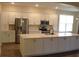 Modern kitchen featuring white cabinets, stainless steel appliances, and a center island at 3621 Arlington Ridge Blvd, Leesburg, FL 34748