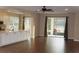 Open living space with wood floors and sliding glass doors leading to a patio at 3621 Arlington Ridge Blvd, Leesburg, FL 34748