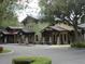 Exterior view of a charming village restaurant featuring stone accents, outdoor seating, and colorful facades at 3621 Arlington Ridge Blvd, Leesburg, FL 34748