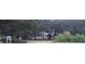 View of community sign surrounded by large trees and lush green landscaping, offering a warm and inviting welcome at 3621 Arlington Ridge Blvd, Leesburg, FL 34748