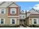 Tan and brown two-story townhome with shutters and a lamp post at 7540 Sunville Ave, Kissimmee, FL 34747