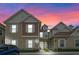 Two-story townhome with light beige and brown siding, and a walkway at 7540 Sunville Ave, Kissimmee, FL 34747