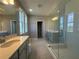 Modern bathroom with double vanity, quartz countertops, and a glass-enclosed shower at 1342 Twelve Oaks Rd, Saint Cloud, FL 34771