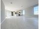 Bright, open-concept living space with gray walls and tile floors flowing into the kitchen at 1342 Twelve Oaks Rd, Saint Cloud, FL 34771