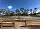 Street lined with tall trees, a wooden fence and a well-maintained paved road at 1342 Twelve Oaks Rd, Saint Cloud, FL 34771