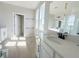 Well-lit bathroom with quartz counters, double sinks, and sleek black fixtures in a contemporary design at 1366 Twelve Oaks Rd, Saint Cloud, FL 34771