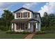 Two-story home with gray siding, red shutters, and landscaping at 1366 Twelve Oaks Rd, Saint Cloud, FL 34771