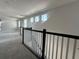 Hallway upstairs featuring carpet flooring and black and white rails at 1366 Twelve Oaks Rd, Saint Cloud, FL 34771