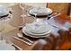 Formal dining table is elegantly set with silverware, plates, and glasses for a special occasion at 2601 Isla Vista Ct, Kissimmee, FL 34747