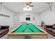 Spacious game room features a pool table, leather sofas, and a ceiling fan for entertainment at 2601 Isla Vista Ct, Kissimmee, FL 34747
