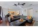 Open-concept living room with a view of the kitchen and dining area, featuring hardwood floors at 2601 Isla Vista Ct, Kissimmee, FL 34747